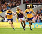 18 June 2022; Conor Devitt of Wexford is tackled by Shane O'Donnell, left, and Ryan Taylor of Clare during the GAA Hurling All-Ireland Senior Championship Quarter-Final match between Clare and Wexford at the FBD Semple Stadium in Thurles, Tipperary. Photo by Ray McManus/Sportsfile