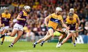 18 June 2022; Ryan Taylor of Clare in action against Conor McDonald, right and Conor Devitt of Wexford during the GAA Hurling All-Ireland Senior Championship Quarter-Final match between Clare and Wexford at the FBD Semple Stadium in Thurles, Tipperary. Photo by Ray McManus/Sportsfile