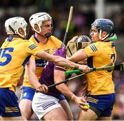 18 June 2022; Conor McDonald of Wexford is tackled by Conor Cleary, right, Cian Nolan and Ryan Taylor of Clare, left, during the GAA Hurling All-Ireland Senior Championship Quarter-Final match between Clare and Wexford at the FBD Semple Stadium in Thurles, Tipperary. Photo by Ray McManus/Sportsfile