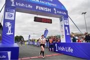19 June 2022; Yvonne Macauley crosses the line to finish third in the womens category during the Irish Life Dublin Race Series – Tallaght 5 Mile at Tallaght in Dublin. Photo by David Fitzgerald/Sportsfile