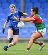 19 June 2022; Aisling Gilsenan of Cavan kicks a point despite the attention of Roisin Flynn of Mayo during the TG4 All-Ireland SFC Group A Round 2 match between Cavan and Mayo at Glennon Brothers Pearse Park in Longford. Photo by Ben McShane/Sportsfile
