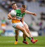 19 June 2022; David Dempsey of Offaly is tackled by Lorcan Dolan of Westmeath during the Tailteann Cup Semi-Final match between Westmeath and Offaly at Croke Park in Dublin. Photo by Ray McManus/Sportsfile