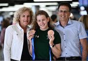 19 June 2022; Róisín Ní Ríain with her parents Marian and Seosamh and her two bronze medals as she arrived home from the IPC Para Swimming World Championships 2022 at Dublin Airport in Dublin. Photo by David Fitzgerald/Sportsfile