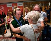 19 June 2022; Ellen Keane is greeted by her parents Eddie and Laura as she arrives home with a silver medal from the IPC Para Swimming World Championships 2022 at Dublin Airport in Dublin. Photo by David Fitzgerald/Sportsfile