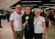 19 June 2022; Ellen Keane with her parents Eddie and Laura and her silver medal as she arrived home from the IPC Para Swimming World Championships 2022 at Dublin Airport in Dublin. Photo by David Fitzgerald/Sportsfile