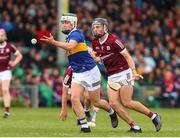 19 June 2022; Tom Delaney of Tipperary in action against Jack Lonergan of Galway during the Electric Ireland GAA Hurling All-Ireland Minor Championship Semi-Final match between Tipperary and Galway at the LIT Gaelic Grounds in Limerick. Photo by Michael P Ryan/Sportsfile