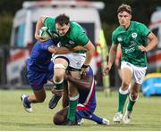 24 June 2022;  Lorcan McLoughlin of Ireland is tackled by Thomas Moukoro of France during the Six Nations U20 summer series match between Ireland and France at Payanini Centre in Verona, Italy. Photo by Roberto Bregani/Sportsfile