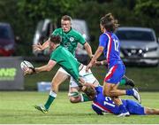 24 June 2022; Lorcan McLoughlin of Ireland offloads the ball as he is tackled by Émilien Gailleton of France during the Six Nations U20 summer series match between Ireland and France at Payanini Centre in Verona, Italy. Photo by Roberto Bregani/Sportsfile