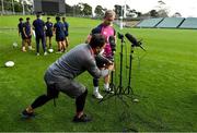 25 June 2022; A cameraman adjusts the height of the microphones for Craig Caseybefore he  speaks to the media after Ireland rugby squad training at North Harbour Stadium in Auckland, New Zealand. Photo by Brendan Moran/Sportsfile