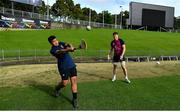 25 June 2022; Ryan Baird watches as De La Salle college student Pesamino Ah Tong Sefo tries hurling after Ireland rugby squad training at North Harbour Stadium in Auckland, New Zealand. Photo by Brendan Moran/Sportsfile