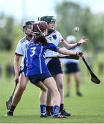 25 June 2022; Eva Ní Fhloinn of Athenry in action against Aoife Curtin of Killeedy during the John West Féile na nGael National Camogie and Hurling Finals, 2022 at the GAA National Games Development Centre Campus, Abbotstown today. Eighty club sides from Ireland, the UK, Europe and US competed in the final stages of the under-15 competition across 10 venues in Dublin and Meath. Sponsored for the seventh time by John West, it is one of the biggest underage sporting events on the continent. Photo by David Fitzgerald/Sportsfile