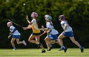 25 June 2022; Emma Hart of Naomh Bríd, Armagh, in action against Ellie Gillan of Tramore, Waterford, during the John West Féile na nGael National Camogie and Hurling Finals at Kiltale GAA in Meath. Photo by Daire Brennan/Sportsfile