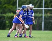 25 June 2022; Tullamore, Offaly, players, left to right, Ellie Lalor, Katie Fogarty, and Anna Maunsell, celebrate during the John West Féile na nGael National Camogie and Hurling Finals at Kiltale GAA in Meath. Photo by Daire Brennan/Sportsfile