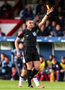 24 June 2022; Referee Rob Hennessy shows a yellow card to Robbie Benson of Dundalk, not pictured, during the SSE Airtricity League Premier Division match between Shelbourne and Dundalk at Tolka Park in Dublin. Photo by Michael P Ryan/Sportsfile