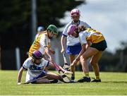 25 June 2022; Emma Corkery of Tramore, Waterford in action against Bella Crossan, left, and Emma Hart of Naomh Bríd, Armagh, during the John West Féile na nGael National Camogie and Hurling Finals at Kiltale GAA in Meath. Photo by Daire Brennan/Sportsfile