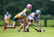 25 June 2022; Ellie Gillan of Tramore, Waterford in action against Anna Carson of Naomh Bríd, Armagh, during the John West Féile na nGael National Camogie and Hurling Finals at Kiltale GAA in Meath. Photo by Daire Brennan/Sportsfile