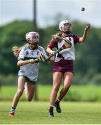 25 June 2022; Kady McNeill of Ruairí Óg Cushendall, Antrim, in action against Ellie McCartney of Swatragh, Derry, during the John West Féile na nGael National Camogie and Hurling Finals at Kiltale GAA in Meath. Photo by Daire Brennan/Sportsfile