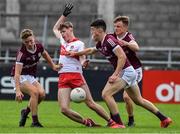 25 June 2022; Ruarí Forbes of Derry in action against Mark Mannion, left, Shay McGlinchey and Ryan Flaherty, right, of Galway during the Electric Ireland GAA All-Ireland Football Minor Championship Semi-Final match between Galway and Derry at Parnell Park, Dublin. Photo by Ray McManus/Sportsfile