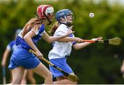 25 June 2022; Caitlin Lowry of Tramore, Waterford, in action against Abbie Maunsell of Tullamore, Offaly, during the John West Féile na nGael National Camogie and Hurling Finals at Kiltale GAA in Meath. Photo by Daire Brennan/Sportsfile
