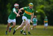 25 June 2022; Cathal Malone of Castleblayney, Monaghan in action against Rory Fennessey of London, during the John West Féile na nGael National Camogie and Hurling Finals at Meath GAA Centre  Dunganny in Meath. Photo by Daire Brennan/Sportsfile