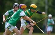 25 June 2022; Tom Duffy of Castleblayney, Monaghan, in action against Conor Glackin of London during the John West Féile na nGael National Camogie and Hurling Finals at Meath GAA Centre  Dunganny in Meath. Photo by Daire Brennan/Sportsfile