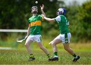 25 June 2022; Seán Meegan of Castleblayney, Monaghan, in action against Michael O'Brien of London during the John West Féile na nGael National Camogie and Hurling Finals at Meath GAA Centre  Dunganny in Meath. Photo by Daire Brennan/Sportsfile