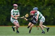 25 June 2022; Paul Grimes of Middletown Na Fianna, Armagh in action against Andrew O'Reilly, left, and Tom Rock, of St Fechin's, Louth, during the John West Féile na nGael National Camogie and Hurling Finals at Meath GAA Centre  Dunganny in Meath. Photo by Daire Brennan/Sportsfile