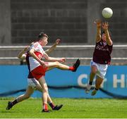 25 June 2022; Antáin Donnelly of Derry, under pressure from Tomás Farthing of Galway, kicks the las kick of the game wide during the Electric Ireland GAA All-Ireland Football Minor Championship Semi-Final match between Galway and Derry at Parnell Park, Dublin. Photo by Ray McManus/Sportsfile