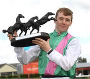 25 June 2022; Jockey Colin Keane celebrates with the trophy after winning The Dubai Duty Free Irish Derby on Westover during the Dubai Duty Free Irish Derby Festival at The Curragh Racecourse in Kildare. Photo by Matt Browne/Sportsfile