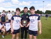 25 June 2022; Meath County Board Assistant Secretary Brian Kelly presents the trophy to New York captains Liam Spillane, left, and Cormac O'Reilly during the John West Féile na nGael National Camogie and Hurling Finals at Boardsmill GAA Club in Meath. Photo by Daire Brennan/Sportsfile