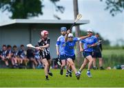 25 June 2022; Jack Gormley of Middletown Na Fianna, Armagh, in action against Adam Dunworth of Longford Slashers, Longford, during the John West Féile na nGael National Camogie and Hurling Finals at Boardsmill GAA Club in Meath. Photo by Daire Brennan/Sportsfile
