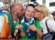 26 June 2022; Special Olympics’ Team Ireland arrived home from Berlin today on Aer Lingus flight EI333 with 14 medals and 6 placement ribbons, won at the 2022 Special Olympics German National Games. Over the past week the team of 11 athletes have given their all and secured medals in all 3 sports they competed in Badminton, Equestrian and Open Water Swimming. These Games are an important steppingstone towards the 2023 World Summer Games which will also take place in Berlin. As official airline of Special Olympics Ireland Aer Lingus ground staff and flight crew were on hand to lend their support in their return journey to Berlin. Kian Johnson Clarke of Team Ireland with his parents Debbie and Michael pictured at Dublin Airport. Photo by Michael P Ryan/Sportsfile