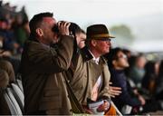 26 June 2022; Racegoers look on from the shelter of the mainstand during a torrential downpour on day three of the Dubai Duty Free Irish Derby Festival at The Curragh Racecourse in Kildare. Photo by David Fitzgerald/Sportsfile