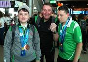 26 June 2022; Special Olympics’ Team Ireland arrived home from Berlin today on Aer Lingus flight EI333 with 14 medals and 6 placement ribbons, won at the 2022 Special Olympics German National Games. Over the past week the team of 11 athletes have given their all and secured medals in all 3 sports they competed in Badminton, Equestrian and Open Water Swimming. These Games are an important steppingstone towards the 2023 World Summer Games which will also take place in Berlin. As official airline of Special Olympics Ireland Aer Lingus ground staff and flight crew were on hand to lend their support in their return journey to Berlin. Declan Foley, left, Kian Johnson Clark of Team Ireland with their coach Cyril McNamara pictured at Dublin Airport. Photo by Michael P Ryan/Sportsfile
