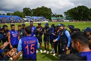 26 June 2022; India debutant Umran Malik, left, is awarded his cap by Bhuvneshwar Kumar before the LevelUp11 First Men's T20 International match between Ireland and India at Malahide Cricket Club in Dublin. Photo by Ramsey Cardy/Sportsfile
