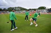 26 June 2022; Ireland players, from left, Andrew Balbirnie, Harry Tector and Conor Olphert warm-up before the LevelUp11 First Men's T20 International match between Ireland and India at Malahide Cricket Club in Dublin. Photo by Ramsey Cardy/Sportsfile