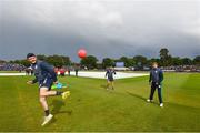 26 June 2022; Ireland players, from left, Stephen Doheny, Mark Adair, and Barry McCarthy, during a rain delay in the LevelUp11 First Men's T20 International match between Ireland and India at Malahide Cricket Club in Dublin. Photo by Ramsey Cardy/Sportsfile