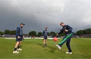 26 June 2022; Ireland players, from left, Stephen Doheny, Mark Adair, and Barry McCarthy, during a rain delay in the LevelUp11 First Men's T20 International match between Ireland and India at Malahide Cricket Club in Dublin. Photo by Ramsey Cardy/Sportsfile