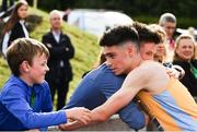 26 June 2022; Darragh McElhinney of UCD AC, Dublin, is congratulated by his brother Eoghan, right, and Iarla, left, after winning the men's 5000m during day two of the Irish Life Health National Senior Track and Field Championships 2022 at Morton Stadium in Dublin. Photo by Sam Barnes/Sportsfile