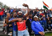 26 June 2022; India supporters celebrate the wicket of Andrew Balbernie of Ireland during the LevelUp11 First Men's T20 International match between Ireland and India at Malahide Cricket Club in Dublin. Photo by Ramsey Cardy/Sportsfile