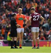 26 June 2022; Referee David Gough with the stand in captains, Rian O'Neill of Armagh and Matthew Tierney of Galway, before the atart of extra time during the GAA Football All-Ireland Senior Championship Quarter-Final match between Armagh and Galway at Croke Park, Dublin. Photo by Ray McManus/Sportsfile