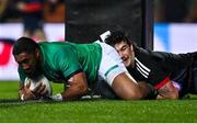 29 June 2022; Bundee Aki of Ireland scores his side's first try despite the tackle of Connor Garden-Bachop of Maori All Blacks during the match between the Maori All Blacks and Ireland at the FMG Stadium in Hamilton, New Zealand. Photo by Brendan Moran/Sportsfile