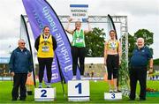 26 June 2022; Athletics Ireland president John Cronin, right, with women's weight for distance 28lbs medallists, from left, Laura McSweeney of Bandon AC, Cork, silver, Laura Dolan of Ferbane AC, Offaly, who won gold with a national record of 7.14m, and Roisin Howard of Bandon AC, Cork, bronze,  during day two of the Irish Life Health National Senior Track and Field Championships 2022 at Morton Stadium in Dublin. Photo by Sam Barnes/Sportsfile