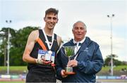 26 June 2022; Cathal Doyle of Clonliffe Harriers AC, Dublin, left is presennted with the cup and medal after winning the men's 1500m by Athletics Ireland competition committee member Paddy Marley during day two of the Irish Life Health National Senior Track and Field Championships 2022 at Morton Stadium in Dublin. Photo by Sam Barnes/Sportsfile