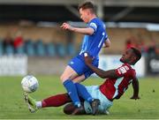 1 July 2022; Conor Melody of Treaty United is tackled by Harlain Mbayo of Cobh Ramblers during the SSE Airtricity League First Division match between Cobh Ramblers and Treaty United at St Colman's Park in Cobh, Cork. Photo by Michael P Ryan/Sportsfile