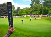 2 July 2022; A marshal holds up a &quot;quiet please&quot; sign as Jack Senior of England putts on the 14th hole during day three of the Horizon Irish Open Golf Championship at Mount Juliet Golf Club in Thomastown, Kilkenny. Photo by Eóin Noonan/Sportsfile
