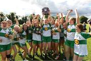 2 July 2022; Aoife Morris captain of Portlaois Co Laois lifts the shield as her team-mates celebrate after the Shield Final between Portlaois Co Laois and Blessington Co Wicklow at the John West National Football Feile 2022 event at Kildare GAA Centre in Hawkfield, Kildare. Photo by Matt Browne/Sportsfile