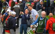 4 July 2022; Former footballer Niall Quinn stops for a selfie as caddy Nicky English, right, makes his way to the 10th tee during day one of the JP McManus Pro-Am at Adare Manor Golf Club in Adare, Limerick. Photo by Eóin Noonan/Sportsfile