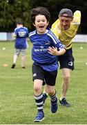 6 July 2022; Barra Thomas, aged 7, with coach Paul McGrath during the 2022 Bank of Ireland Leinster Rugby Inclusion Camp at St Mary's College RFC in Dublin. Photo by Sam Barnes/Sportsfile