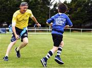 6 July 2022; Coach Paul McGrath chases Barra Thomas, aged 7, during the 2022 Bank of Ireland Leinster Rugby Inclusion Camp at St Mary's College RFC in Dublin. Photo by Sam Barnes/Sportsfile